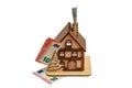 Euro bill in chimney and a wooden toy symbolic house on white isolated background. Heating concept Royalty Free Stock Photo