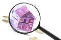 Euro bill House and expenses under magnifying glass Royalty Free Stock Photo