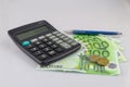 100 euro bills euro banknotes and coins money with calculator and pen. European Union Currency.  Isolated background Royalty Free Stock Photo