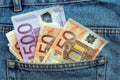 Euro bills in a blue jeans pocket