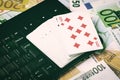 Euro bills, a deck of playing cards and a black keyboard. Concept of card games, casino or poker online. Royalty Free Stock Photo