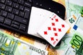 Euro bills, a deck of playing cards and a black keyboard. Concept of card games, casino or poker online Royalty Free Stock Photo