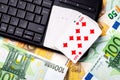 Euro bills, a deck of playing cards and a black keyboard. Concept of card games, casino or poker online Royalty Free Stock Photo