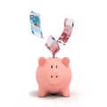 Euro bills falling in or flying out of a pink piggy bank Royalty Free Stock Photo