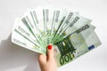 Euro bills in female hands. Euro cash background on white, fan of 100 euros Royalty Free Stock Photo