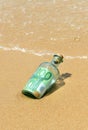 100 euro in a bottle on the beach Royalty Free Stock Photo