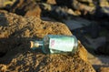100 euro in a bottle on the rocks of the beach Royalty Free Stock Photo