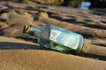 100 euro in a bottle on the sand Royalty Free Stock Photo