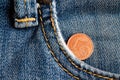 Euro coin with a denomination of 1 euro cent in the pocket of old worn blue denim jeans Royalty Free Stock Photo