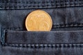 Euro coin with a denomination of 5 euro cents in the pocket of worn gray denim jeans Royalty Free Stock Photo