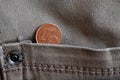 Euro coin with a denomination of 1 euro cent in the pocket of old worn gray denim jeans Royalty Free Stock Photo