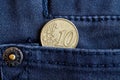 Euro coin with a denomination of 10 euro cents in the pocket of dark blue denim jeans Royalty Free Stock Photo