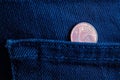 Euro coin with a denomination of one euro cent in the pocket of old dark blue denim jeans Royalty Free Stock Photo