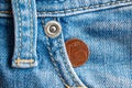 Euro coin with a denomination of one euro cent in the pocket of old worn vintage blue denim jeans Royalty Free Stock Photo