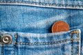 Euro coin with a denomination of one euro cent in the pocket of worn old blue denim jeans Royalty Free Stock Photo