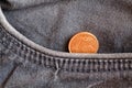 Euro coin with a denomination of one euro cent in the pocket of old blue denim jeans Royalty Free Stock Photo