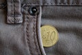 Euro coin with a denomination of ten euro cent in the pocket of worn gray denim jeans Royalty Free Stock Photo