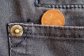 Euro coin with a denomination of two euro cent in the pocket of dark blue denim jeans