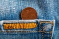 Euro coin with a denomination of two euro cent in the pocket of worn blue denim jeans whis orange seam Royalty Free Stock Photo