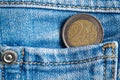 Euro coin with a denomination of 2 euro in the pocket of dark blue denim jeans Royalty Free Stock Photo