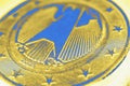 1 euro coin issued in Germany close up. Obverse with the Federal Eagle. Yellow and blue tinted economic background or backdrop. Royalty Free Stock Photo