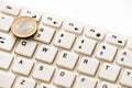 Euro coin lies on the number one computer keyboard. Conceptual image on the topic of finance and computer technology. How to make Royalty Free Stock Photo