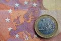 Euro coin on euro map from banknote revers