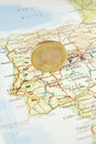Euro Coin on a Map of Portugal Royalty Free Stock Photo