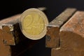 2 Euro coin in a metal vise. Concept of economic problems. Selective focus. Close up Royalty Free Stock Photo