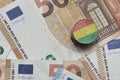 euro coin with national flag of bolivia on the euro money banknotes background