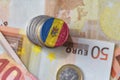 Euro coin with national flag of moldova on the euro money banknotes background.
