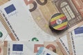 euro coin with national flag of uganda on the euro money banknotes background