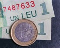 1 euro coin over 1 leu RON bills