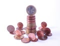 1 Euro coin standing on top of stack of euro coins surrounded by smaller value standing coins Royalty Free Stock Photo