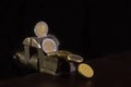 Euro coins clamped in a vice-grip on dark background