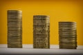 Euro coins and eurocents stacked on a yellow background. Euro m Royalty Free Stock Photo