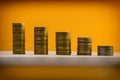 Euro coins and eurocents stacked on a yellow background. Euro mo Royalty Free Stock Photo