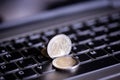 Euro coins on laptop& x27;s keyboard Royalty Free Stock Photo