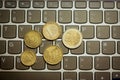 Euro coins on laptop& x27;s keyboard Royalty Free Stock Photo