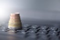 Euro coins lie in the form of a pyramid on a laptop keyboard Royalty Free Stock Photo