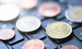 Euro coins lie on the laptop keyboard, close-up Royalty Free Stock Photo