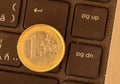 Euro coins lie on a laptop keyboard. Close up, space for text. C Royalty Free Stock Photo