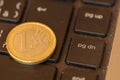 Euro coins lie on a laptop keyboard. Close up, space for text. C Royalty Free Stock Photo