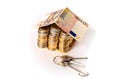 Euro Coins pile House with banknote roof and key Royalty Free Stock Photo