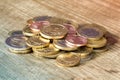 Euro coins piled on wooden table Royalty Free Stock Photo