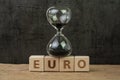 Euro countdown after Brexit referendum to withdraw from Europe, hourglass or sandglass on wooden cube block with alphabet building Royalty Free Stock Photo