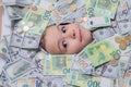 Euro and dollar concept. Money win, big luck. Kid with fun face in money. Kid peeking out of dollar bills with Royalty Free Stock Photo