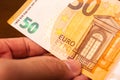 Euro, European Union Currency. A man holding a fifty euro bill. Close-up photo. Royalty Free Stock Photo