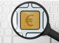 Euro icon under the magnifying glass Royalty Free Stock Photo