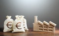 Euro money bags and industrial factory plant. Investment modernization, automation, reduction of the impact on environment. Royalty Free Stock Photo